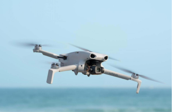 DJI Mini drone flying above the sea